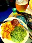 A Wagu burger with spinach and potatoes