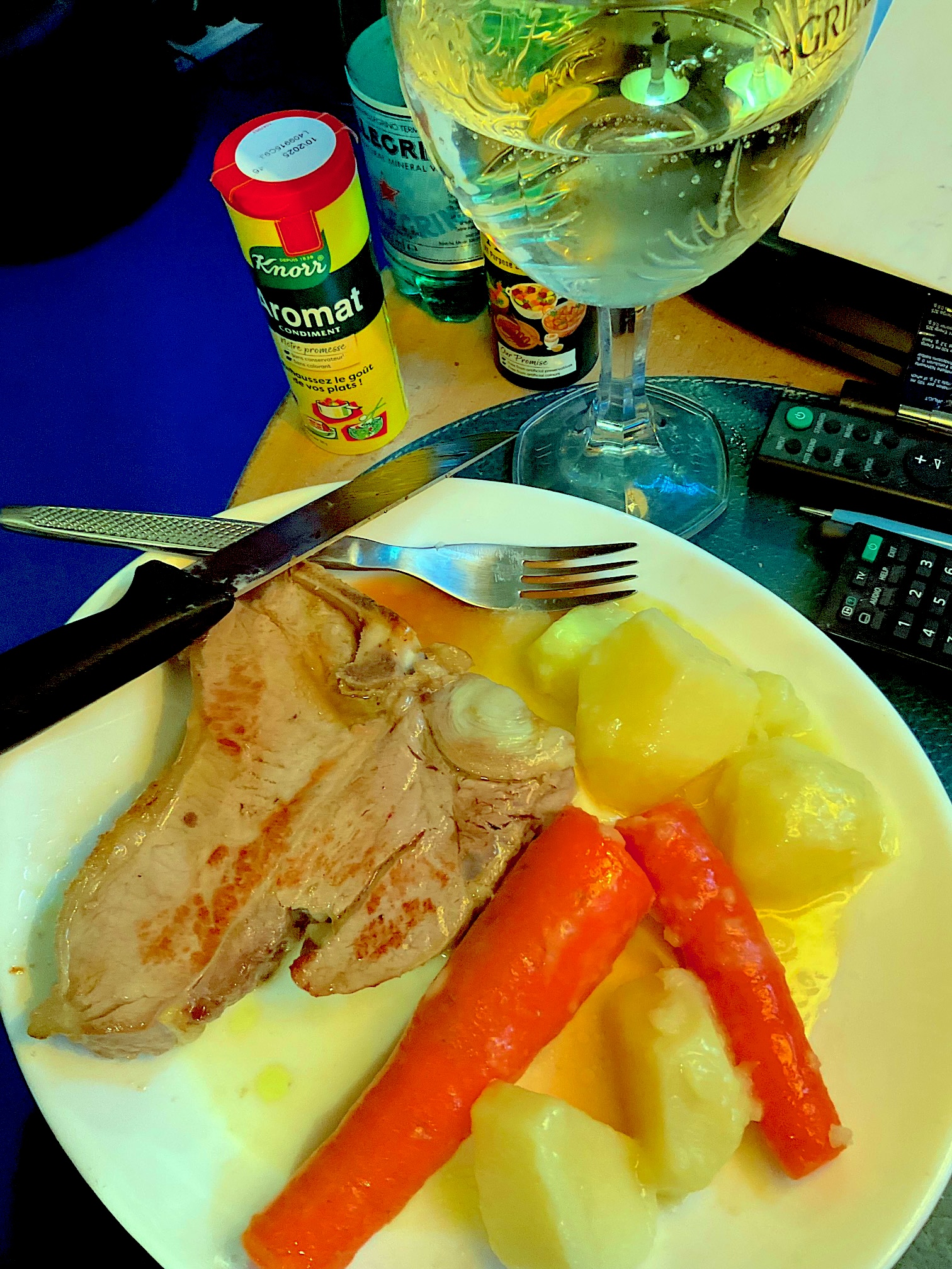 A veal chop with potatoes and carrots