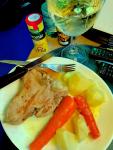 A veal chop with potatoes and carrots