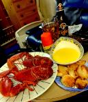 A Lobster, butter, roast potatoes and artichoke dinner.